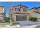 Two-story house with brown garage door and landscaping at 5648 Ancient Agora St, North Las Vegas, NV 89031