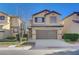 Charming two-story home with a well-manicured lawn, inviting curb appeal, and an attached two-car garage at 5648 Ancient Agora St, North Las Vegas, NV 89031