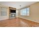 Living room with stone fireplace, hardwood floors and large windows at 5648 Ancient Agora St, North Las Vegas, NV 89031