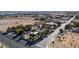 Aerial view of a house and large lot with surrounding desert landscape at 5785 W Russell Rd, Las Vegas, NV 89118