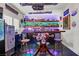 Unique home bar with bar stools, custom lighting, and an automobile themed interior at 5805 Cabo San Lucas Ave, Las Vegas, NV 89131