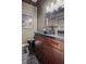 Elegant bathroom featuring wood cabinets, a vessel sink, stylish vanity mirror, and updated fixtures at 5805 Cabo San Lucas Ave, Las Vegas, NV 89131