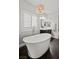 Serene bathroom with a standalone tub, modern faucet, plantation shutters, and elegant lighting fixture at 5805 Cabo San Lucas Ave, Las Vegas, NV 89131