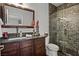 Well-appointed bathroom features a glass enclosed shower with tiled surround, updated vanity, and a stylish mirror at 5805 Cabo San Lucas Ave, Las Vegas, NV 89131