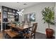 Bright dining room featuring modern light fixture, hardwood floors, and a large dining table at 5805 Cabo San Lucas Ave, Las Vegas, NV 89131