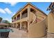 Stunning exterior view of a multi-story home with a curved staircase leading to an outdoor bar area and swimming pool at 5805 Cabo San Lucas Ave, Las Vegas, NV 89131