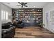 Spacious living room with custom built-in bookshelves, wood flooring, and comfortable seating at 5805 Cabo San Lucas Ave, Las Vegas, NV 89131