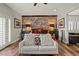 Inviting main bedroom features a brick accent wall, wood floors, and a cozy seating area with soft textures at 5805 Cabo San Lucas Ave, Las Vegas, NV 89131