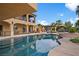Expansive pool with a baja shelf, in-ground spa, and an outdoor kitchen, perfect for entertaining at 5805 Cabo San Lucas Ave, Las Vegas, NV 89131