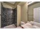 Cozy bathroom featuring tiled shower, toilet, and a vanity with a sink, enhanced by neutral wall paint at 5915 Poplar Tree St, Las Vegas, NV 89148