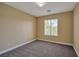 Neutral-toned bedroom with plush carpeting, a window providing natural light, and baseboard trim at 5915 Poplar Tree St, Las Vegas, NV 89148