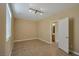 The neutral-painted bedroom features tile floors, track lighting, and natural light at 5915 Poplar Tree St, Las Vegas, NV 89148
