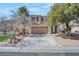 Charming two-story home featuring a well-maintained yard and a two-car garage, located in a suburban neighborhood at 5915 Poplar Tree St, Las Vegas, NV 89148