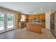 Well-lit kitchen featuring stainless steel appliances, wooden cabinetry, and a central island at 5915 Poplar Tree St, Las Vegas, NV 89148