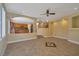Open-concept living space with tile flooring, ceiling fan, and seamless access to the kitchen area at 5915 Poplar Tree St, Las Vegas, NV 89148