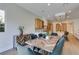 Modern dining room with a wood table and gray chairs near kitchen at 6009 Silvalde Ln, Las Vegas, NV 89135