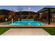 Luminous pool at night with a pergola and outdoor kitchen at 6009 Silvalde Ln, Las Vegas, NV 89135