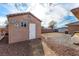 Tan colored shed with white door in backyard at 6781 Southgate St, Pahrump, NV 89061