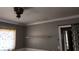 Bedroom with gray walls, a shelf, and floral curtains at 744 Willow Ave, Henderson, NV 89002