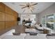 Open concept living room with wood wall and kitchen access at 8838 Sorrel Hills Ct, Las Vegas, NV 89113
