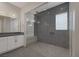 Large walk-in shower with gray tile and built-in seat at 8838 Sorrel Hills Ct, Las Vegas, NV 89113