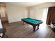 Game room with pool table, hardwood floors, and access to stairs at 8959 Fox Season Ave, Las Vegas, NV 89178