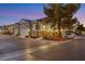 Tan two-story home with attached garage and landscaped yard at 9100 Kings Town Ave, Las Vegas, NV 89145