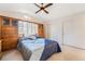 Main bedroom with built-in wooden cabinets and ceiling fan at 9785 Gallo Dr, Las Vegas, NV 89147