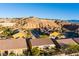 Aerial view of houses nestled in a desert landscape with mountain views at 993 Starlight Terrace Way, Mesquite, NV 89034