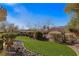 Landscaped backyard with artificial turf and rock features at 993 Starlight Terrace Way, Mesquite, NV 89034