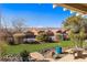 Landscaped backyard with covered patio, artificial turf, and mountain views at 993 Starlight Terrace Way, Mesquite, NV 89034