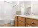 Clean bathroom with tub, toilet and wood vanity at 993 Starlight Terrace Way, Mesquite, NV 89034