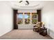 Serene bedroom with large windows, carpeting, and a comfortable armchair at 993 Starlight Terrace Way, Mesquite, NV 89034