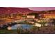 Inviting community entrance with stone signage, water features, and lush landscaping set against a mountain backdrop at 993 Starlight Terrace Way, Mesquite, NV 89034