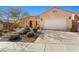 Landscaped yard with a walkway leading to a charming house exterior at 993 Starlight Terrace Way, Mesquite, NV 89034