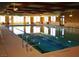 Bright indoor pool with large windows and ample seating offers a refreshing and relaxing aquatic experience at 993 Starlight Terrace Way, Mesquite, NV 89034