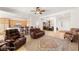 Open living room with leather furniture, a fireplace and views to kitchen at 993 Starlight Terrace Way, Mesquite, NV 89034
