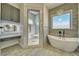 Bathroom showcasing a standalone tub, frameless glass shower, modern fixtures, and stylish design at 1131 Blackhorn St, Pahrump, NV 89048