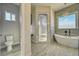 Bathroom with a soaking tub, walk-in shower, and wood-look tile flooring at 1131 Blackhorn St, Pahrump, NV 89048