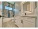Modern bathroom featuring a white vanity, a lighted mirror, and a tiled tub and shower combination at 1131 Blackhorn St, Pahrump, NV 89048