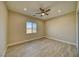 Bright bedroom featuring wood-look tile flooring, neutral walls, a ceiling fan, and a picturesque window view at 1131 Blackhorn St, Pahrump, NV 89048