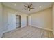 This bedroom has wood-look tile flooring, neutral walls, closet, and a ceiling fan at 1131 Blackhorn St, Pahrump, NV 89048