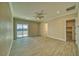 Spacious bedroom boasting wood-look tile flooring, neutral walls, and a sliding glass door to the patio at 1131 Blackhorn St, Pahrump, NV 89048
