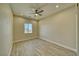 This bedroom features a ceiling fan, recessed lighting, wood-look flooring and a window letting in natural light at 1131 Blackhorn St, Pahrump, NV 89048