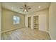 Neutral bedroom with a ceiling fan, a window, and closet space at 1131 Blackhorn St, Pahrump, NV 89048