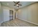 This bedroom features a ceiling fan, recessed lighting, wood-look flooring and a closet with white sliding doors at 1131 Blackhorn St, Pahrump, NV 89048