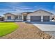 Attractive single-story home with a well-manicured lawn, desert landscaping, and an inviting entrance at 1131 Blackhorn St, Pahrump, NV 89048