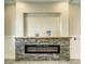 Modern electric fireplace with a stone surround and mantel, enhancing the room's cozy ambiance at 1131 Blackhorn St, Pahrump, NV 89048