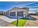 Spacious three-car garage featuring a concrete driveway and minimalist landscaping at 1131 Blackhorn St, Pahrump, NV 89048