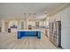 Spacious kitchen showcasing modern cabinetry, stainless steel refrigerator, a blue island, and stylish backsplash at 1131 Blackhorn St, Pahrump, NV 89048